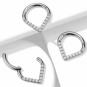 G23 titanium hinged nose clicker ring with sparkling clear zircon stones on a white base