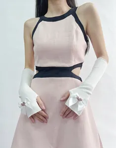 Detail of white knit arm warmers with satin bows and pink heart sequins for JK style