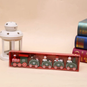 Detail shot of a festive red and green wooden Christmas train set in PVC packaging