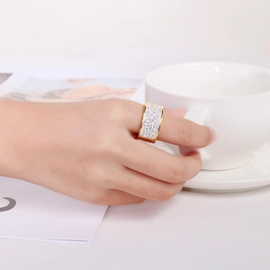 Close-up of a wide 18k gold plated stainless steel ring with full pavé crystals on finger