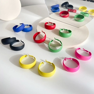 Detailed close-up of macaron colored hoop earrings with matte enamel finish