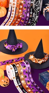 Detail of Halloween grosgrain ribbons featuring pumpkin and spider web festive patterns