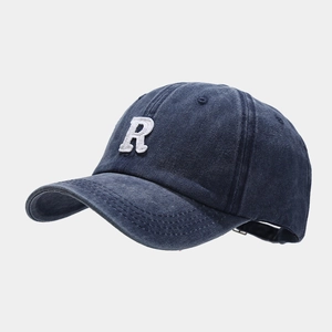 Detail of vintage washed blue baseball cap with white towel-embroidered R letter