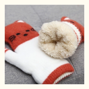 Detail of warm knitted cat gloves with thick plush lining and cute embroidery
