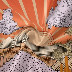 Detailed close-up showing fabric texture of a bohemian desert sunset tapestry with mountains