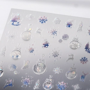 Holographic Christmas nail decals featuring silver laser snowflakes and reindeer patterns