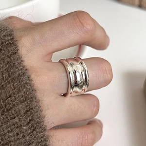 Minimalist wide band 925 sterling silver ring with polished finish on model hand