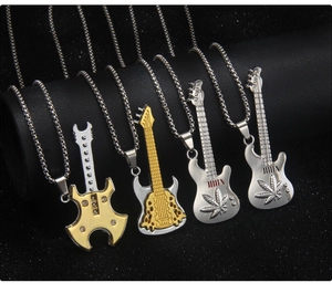 Detail of colorful guitar pendant necklaces on a black display stand in various finishes