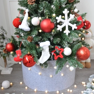 Grey felt Christmas tree collar with festive hanging ornaments and warm LED fairy lights