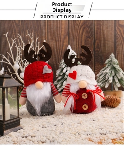 Detail of Christmas gnomes with knitted hats and reindeer antlers on festive snow background