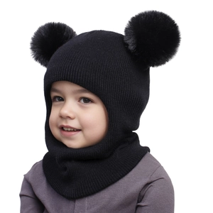Close-up of black knitted baby balaclava featuring cute double faux fur pom-poms