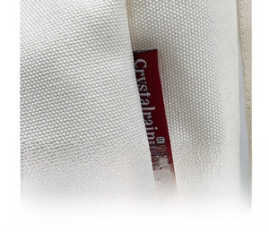 Detailed close-up of white canvas bag showing stitching and red Crystalvain brand label