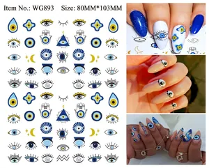 Detail of blue evil eye nail stickers with Fatima hand and moon motifs for DIY manicure