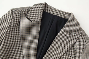 Detail shot of classic houndstooth blazer lapel with high-quality fabric texture and lining