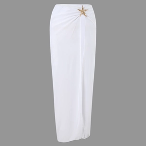 Detail of white sarong featuring a gold starfish metal buckle and elegant ruching