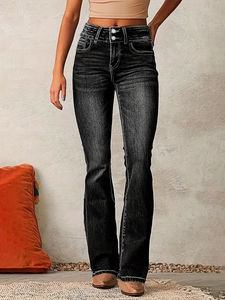 Detail of high waisted retro flared jeans with double button design and washed texture
