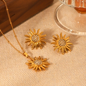 18K gold stainless steel sunflower jewelry set with sparkling crystals on burlap