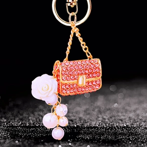 Pink rhinestone handbag keychain with white rose and pearls on gold-plated chain