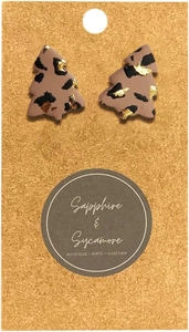 Close-up of leopard print Christmas tree stud earrings with elegant gold foil details