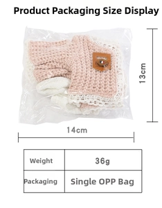 Pink knit doll clothing accessory with white lace edge and leather brand label