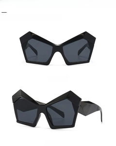 Front and side view of irregular black geometric oversized sunglasses with grey lenses