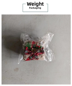 Detailed view of plush Christmas gift box ornament with red and green plaid ribbon bow