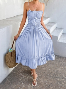 Detail view of light blue A-line dress with ruffled hem and white lace-up tie accents