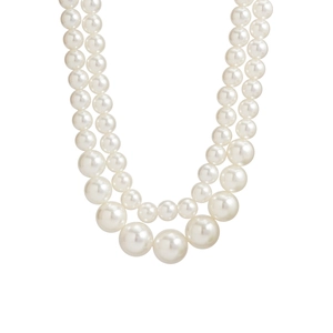 Detailed view of layered cream white faux pearl necklace with gradient bead sizing