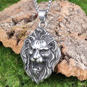 Detailed lion head pendant necklace in stainless steel on natural wood and moss background