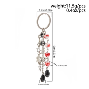 Detail view of bow keychain with marble beads, black facets, and hollow star charms