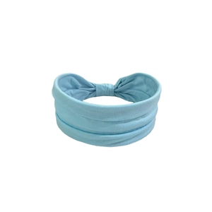 Elastic light blue yoga headband with a twist knot design and soft pleated fabric