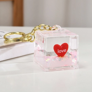 Pink quicksand liquid keychain with red heart and love engraving in acrylic cube