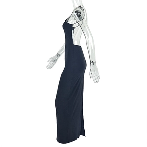 Side view of a slim-fit black backless halter dress with a high side slit detail