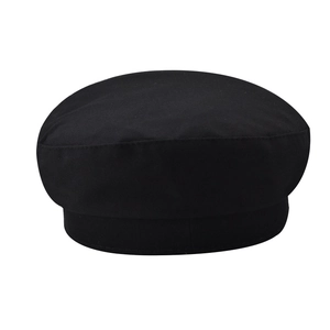 Detail of classic black cotton newsboy cap with vintage British twill texture