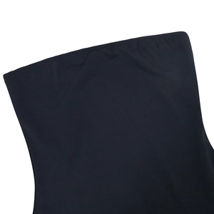 Detailed macro shot of black tube top dress edge with elegant lettuce trim texture