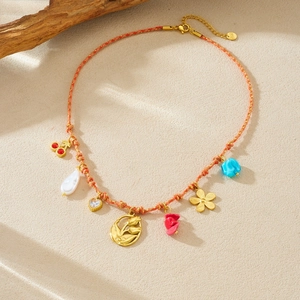 Bohemian braided orange cord necklace with colorful tulip charms and gold elephant pendant