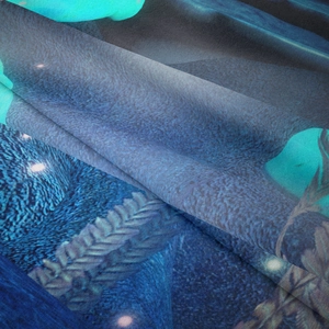 Close-up of blue floral mushroom tapestry fabric showing fine weaving and soft draping