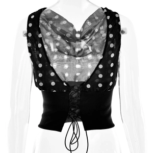 Detail of polka dot mesh patchwork top with waist-cinching lace-up front design