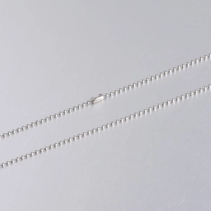 Macro shot of 1.5mm stainless steel ball chain jewelry featuring a secure clasp connector