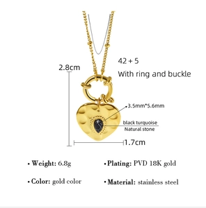 Detail of heart pendant necklace in 18K gold plated stainless steel with black stone