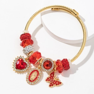 Golden spiral beaded bracelet with red crystal charms and Virgin Mary pendant