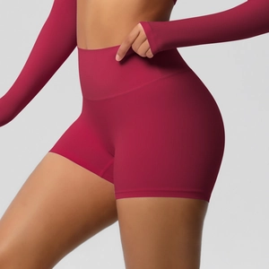 Close-up of high-waisted dark red yoga shorts with seamless lift and smooth texture