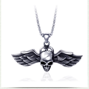Macro shot of stainless steel skull pendant with wings on a heavy metal chain
