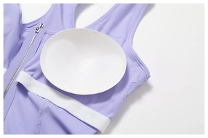 Detail view of sports dress with front zipper and removable circular breast pads