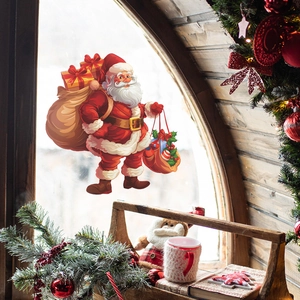 Detail of Christmas Santa Claus wall sticker on window with festive holiday decorations