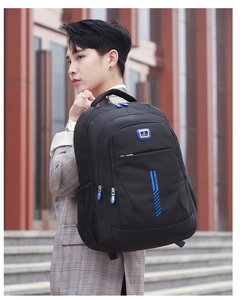 Outdoor view of a black waterproof sports backpack with blue S Sport logo and side mesh pocket