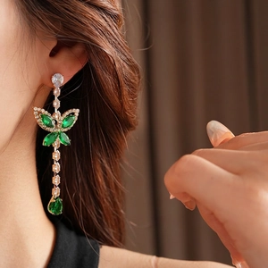 Elegant gold butterfly drop earrings with green zircon tassels in a luxury French style