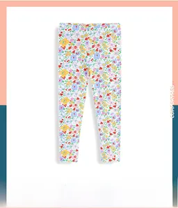 Detailed close-up of girls floral leggings with colorful flower patterns on white fabric