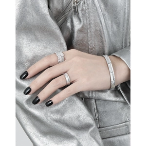 Matte S925 sterling silver bangle and star embossed rings with a cool industrial style
