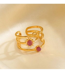 Detail of adjustable gold sun and moon ring with purple stones on champagne silk